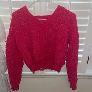 Pink cropped sweater with a “worn” texture